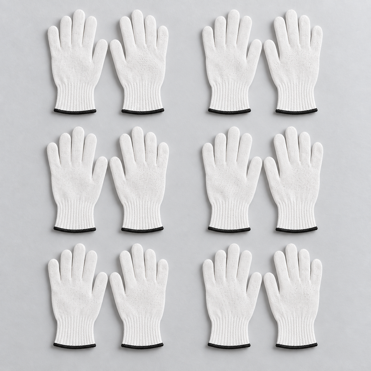 Twelve individual Wees Express white cotton butcher gloves arranged as six pairs to show one pack's quantity