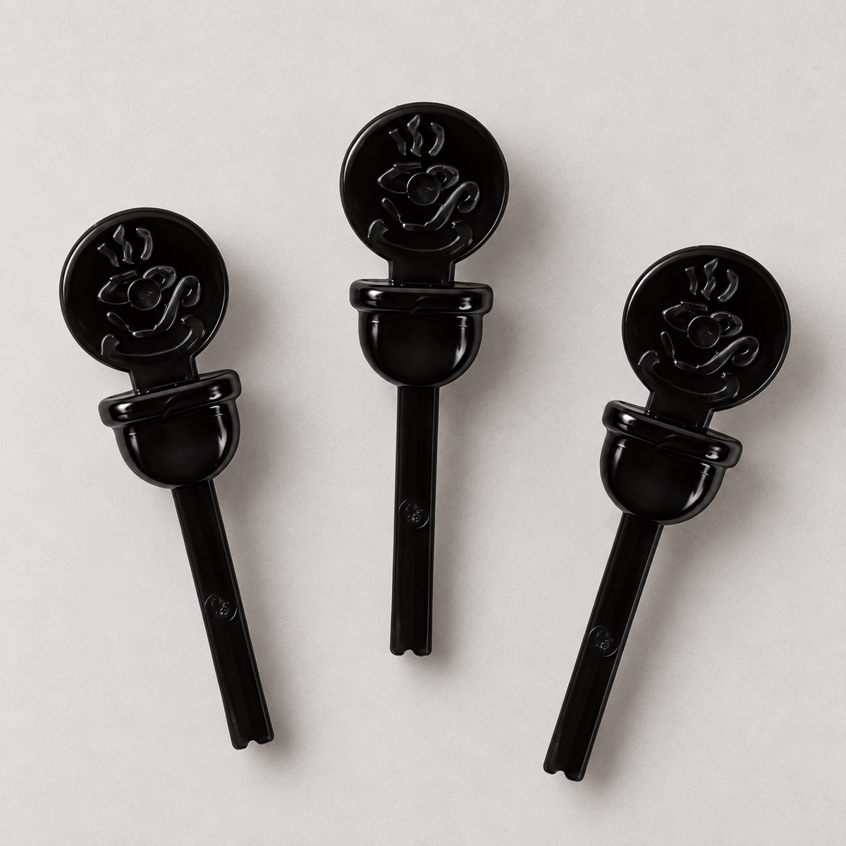 AmerCareRoyal CPLUG-BK black beverage plugs showing circular heads and insertion stems; AI-assisted detail view