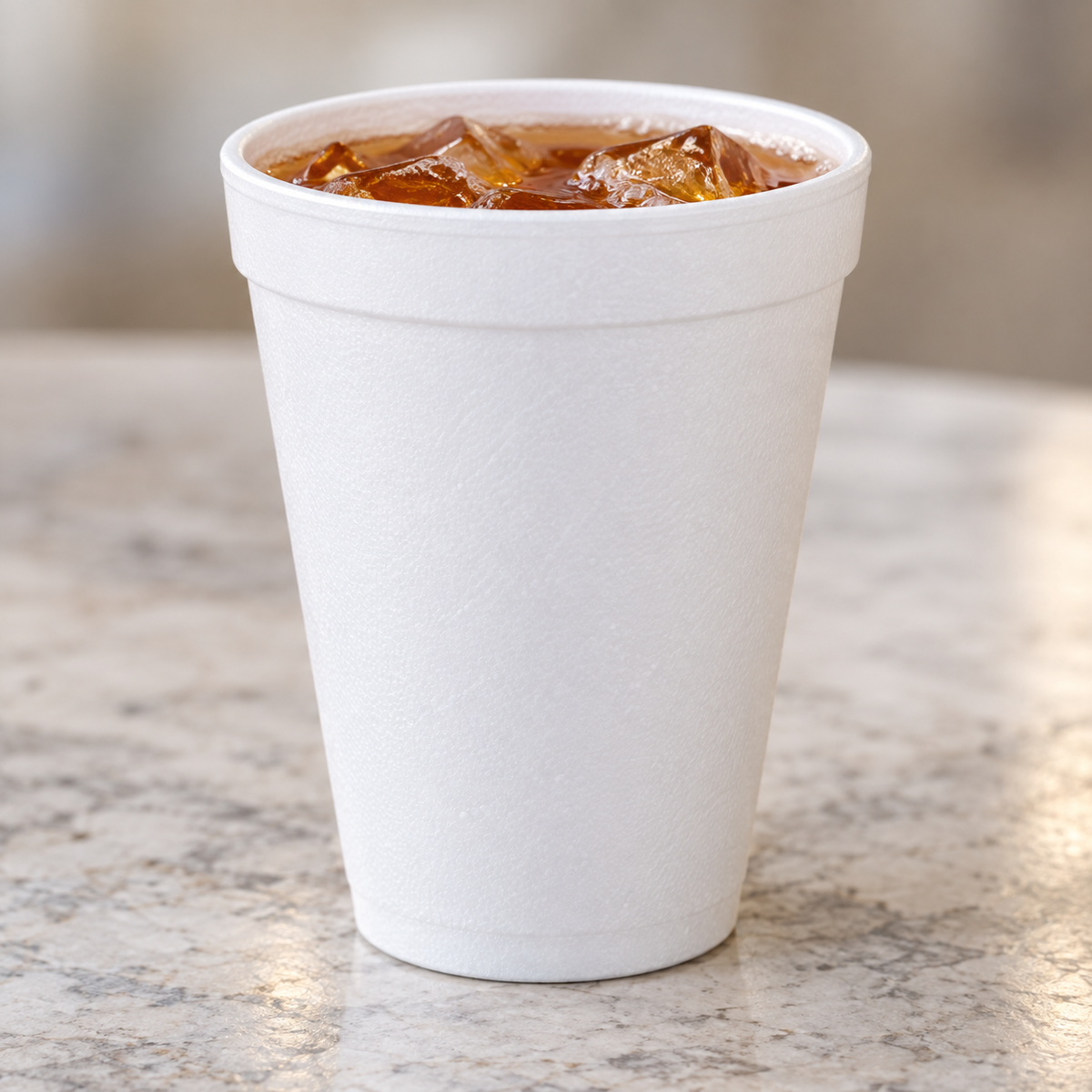 Dart 12J16 white insulated foam cup with iced tea, beverage not included