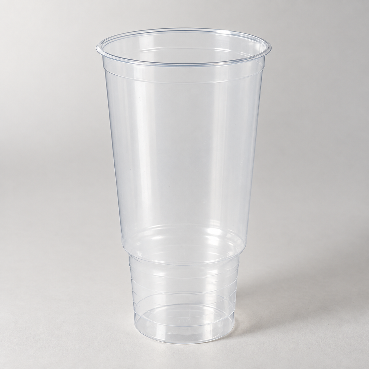 Dart 32P 32 oz clear PP pedestal cold cup, empty unwrapped cup on a white studio background