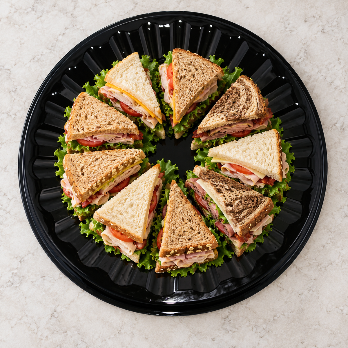 DFI CP-18 18-inch black party tray arranged with sandwich halves; food shown for serving inspiration