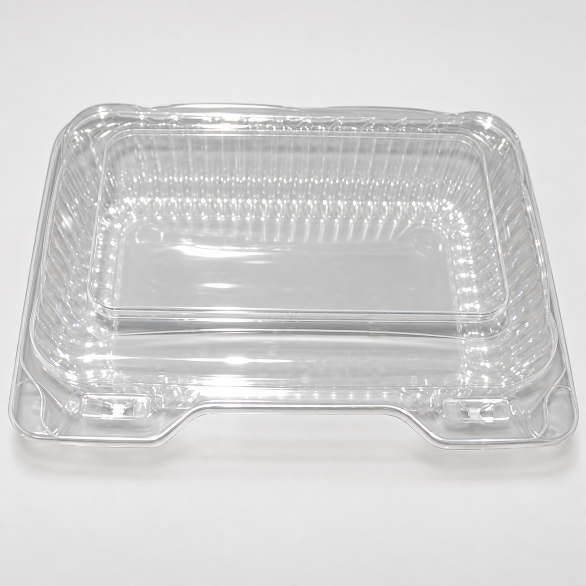 DFI LBH-571 clear OPS rectangular hinged container showing the empty base, flat lid and front closure