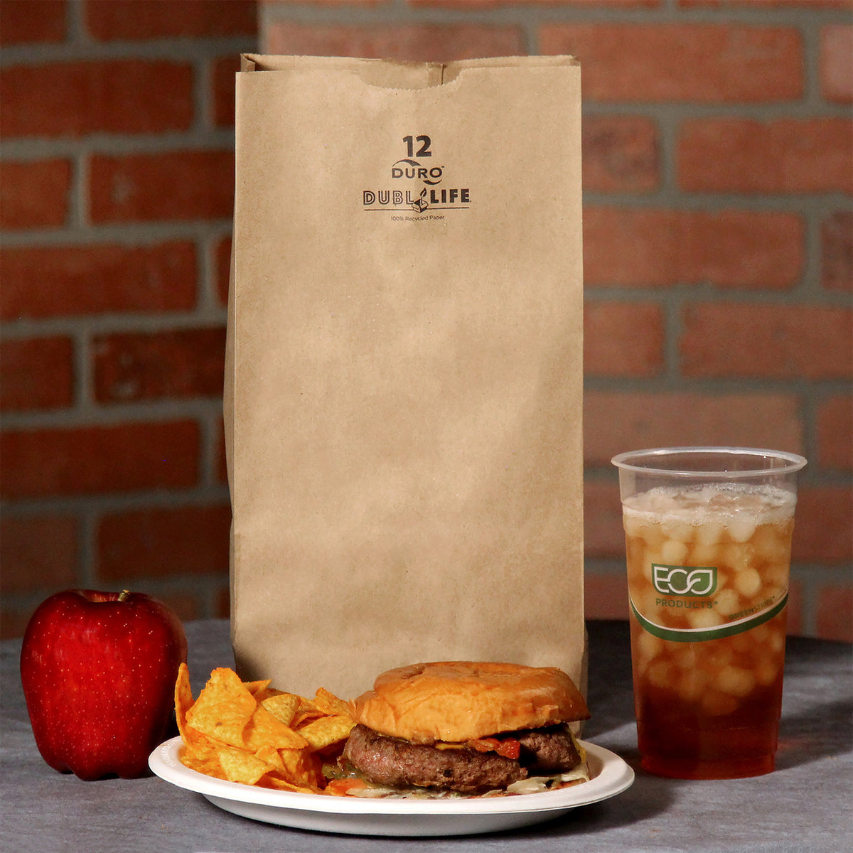 Dubl Life 18412 kraft grocery bag beside a prepared lunch, manufacturer photo; food and drink not included