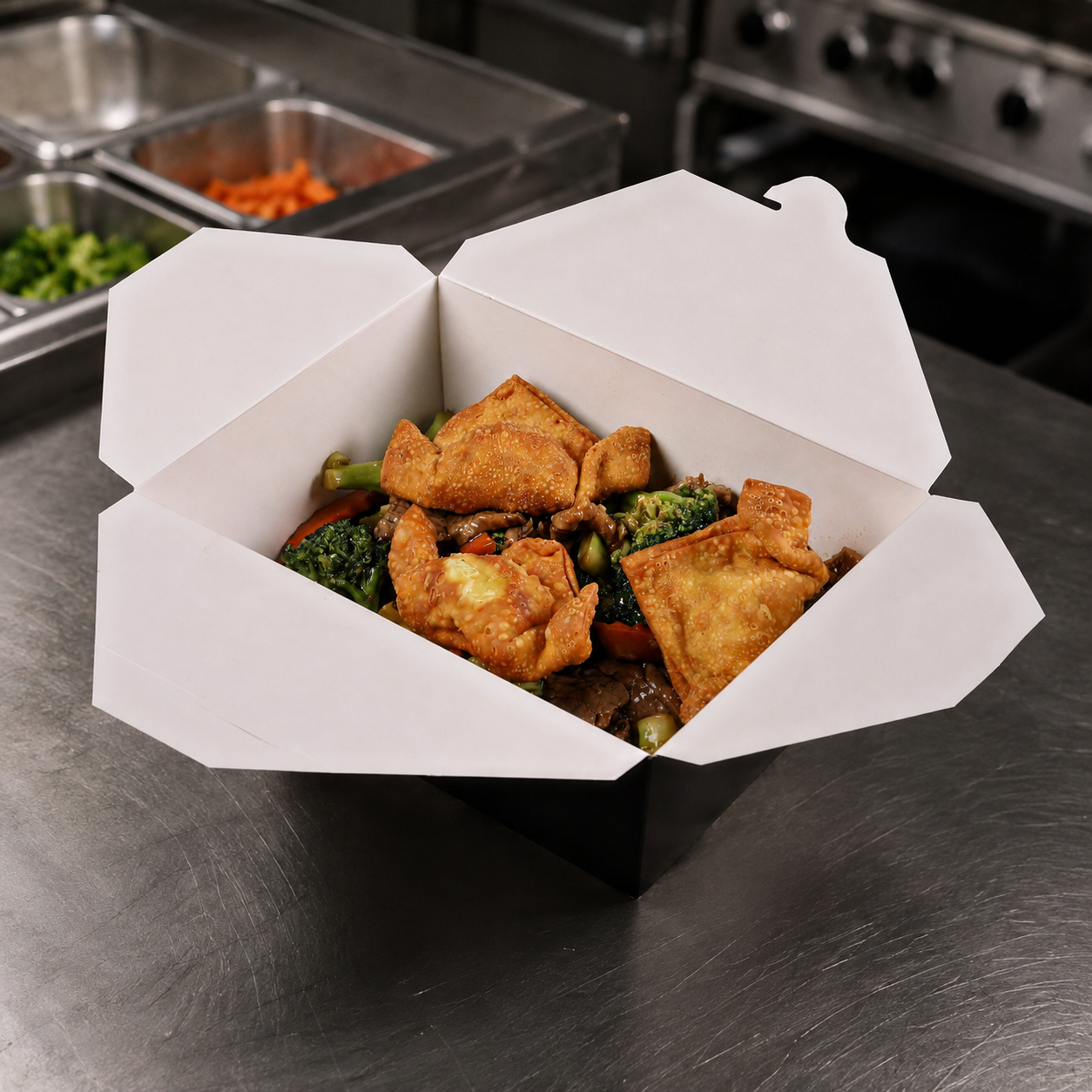 Empress #4 black paper takeout box with white interior and prepared food in a commercial kitchen