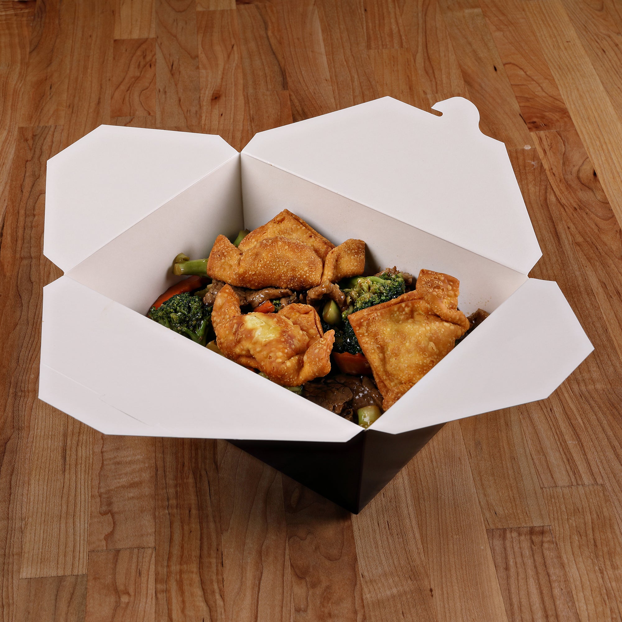 Empress EMPFDBX4-B black paper takeout box with white interior shown filled with prepared food