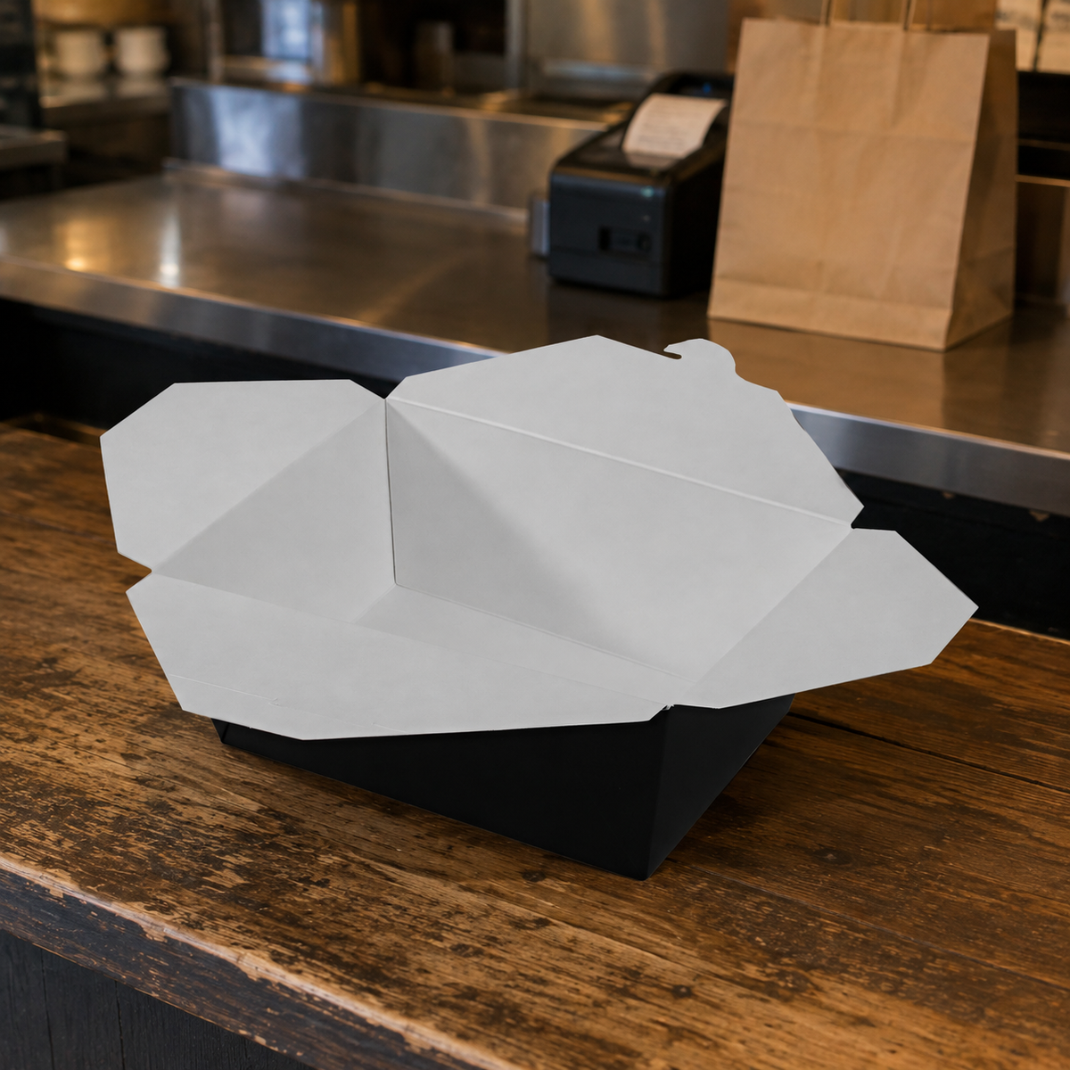 Empress #4 black and white paper takeout box at a restaurant pickup counter