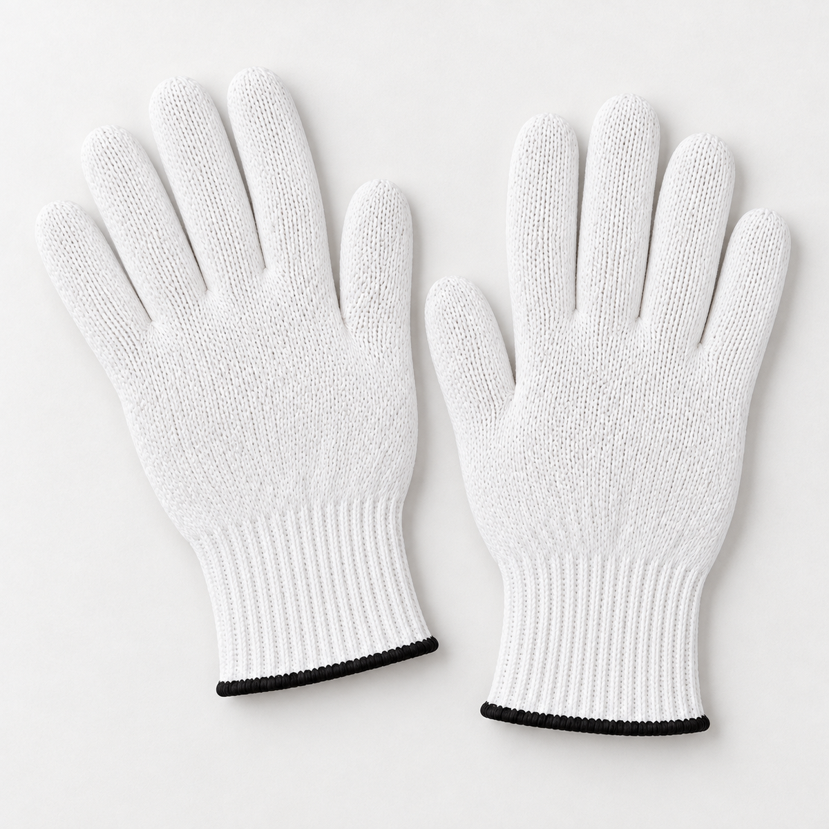 One unworn pair of Wees Express white cotton butcher gloves showing full fingers and black-edged ribbed cuffs